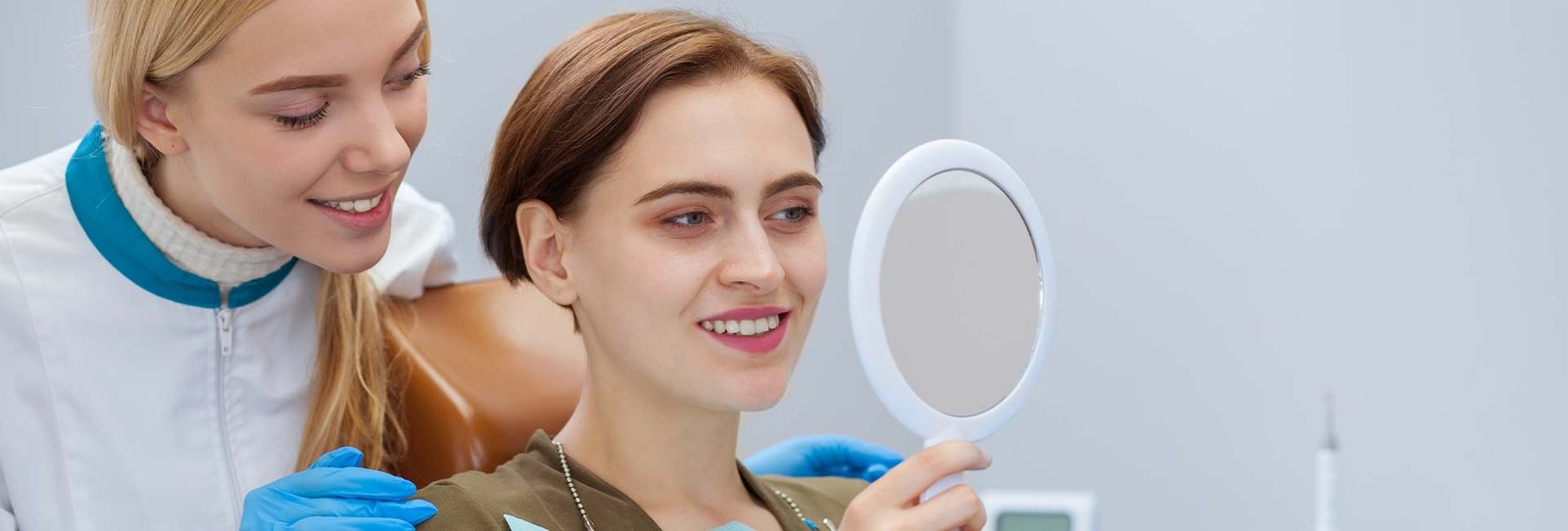 A woman checking her teeth in the mirror