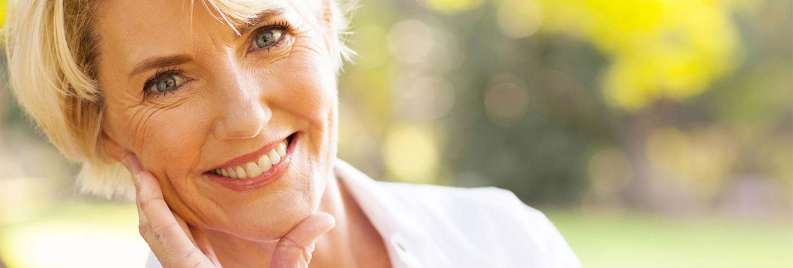 Closeup of an old happy woman outdoors