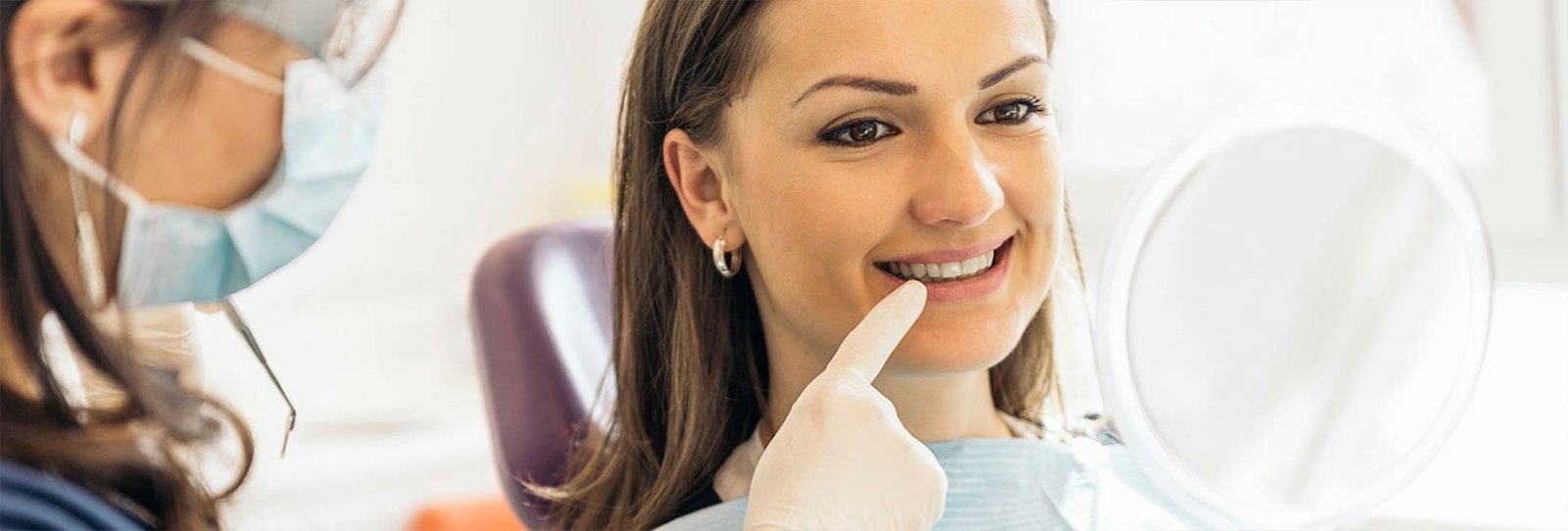 A staff pointing to patients' teeth