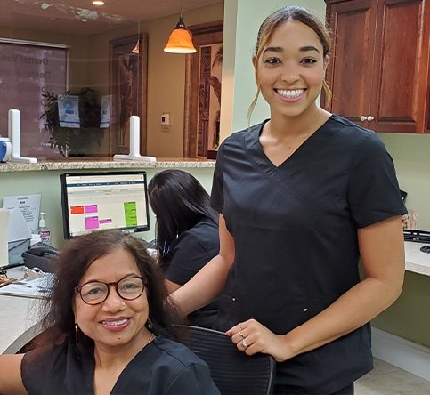 Three dental team members ready to help maximize dental insurance
